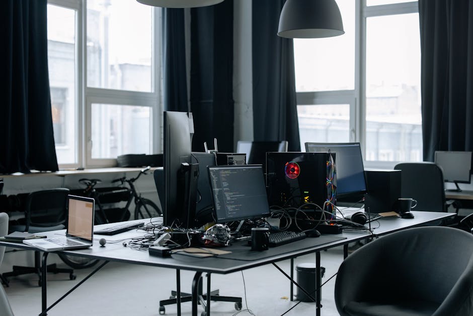 Contemporary workspace featuring computers, coding screens, and office essentials